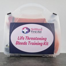 A transparent case with the label life threatening bleeds training kit on the front.